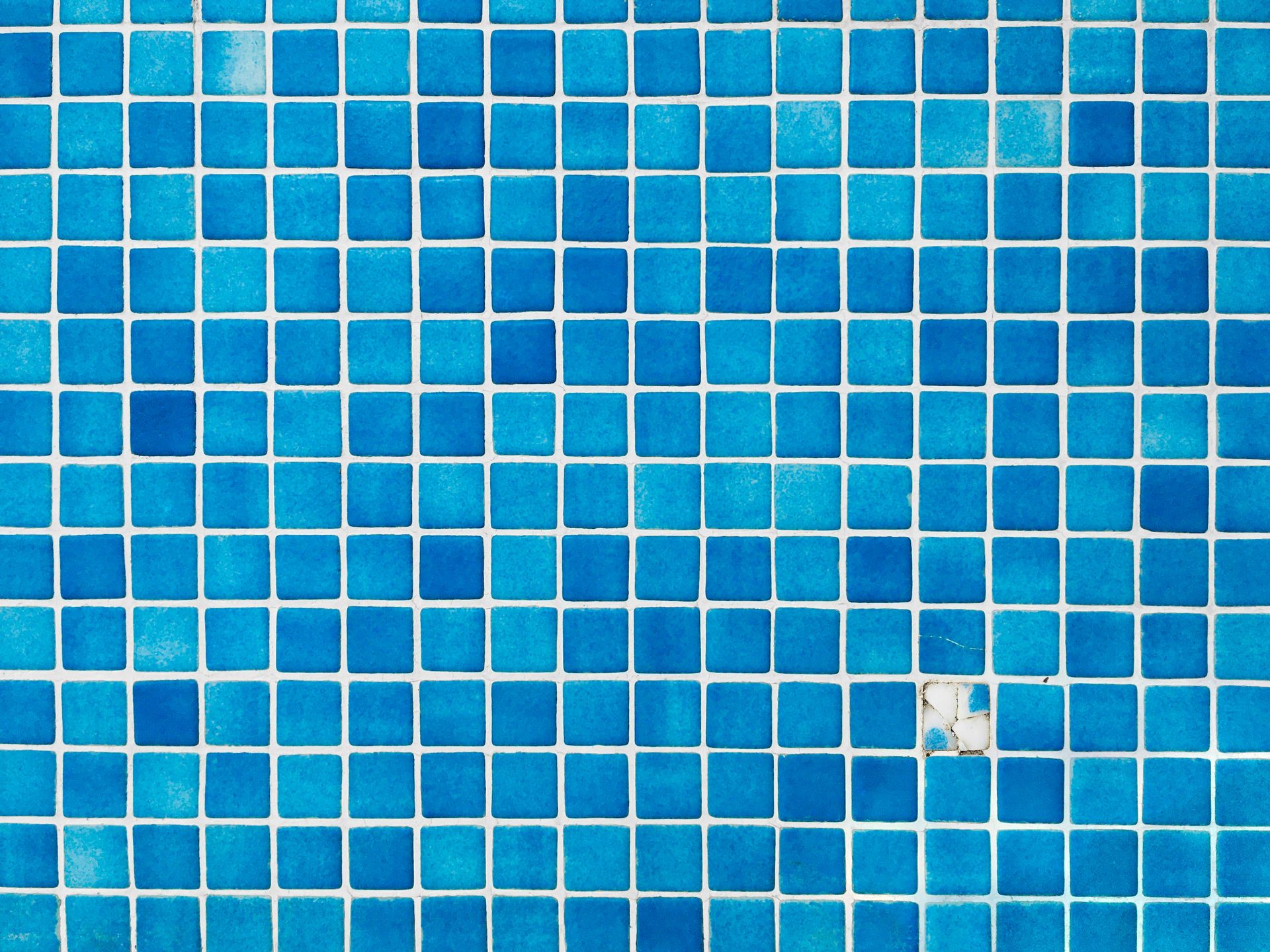 a close up of a blue tiled wall